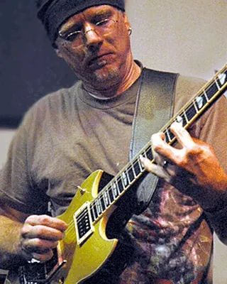 Chris Poland with a yellow guitar